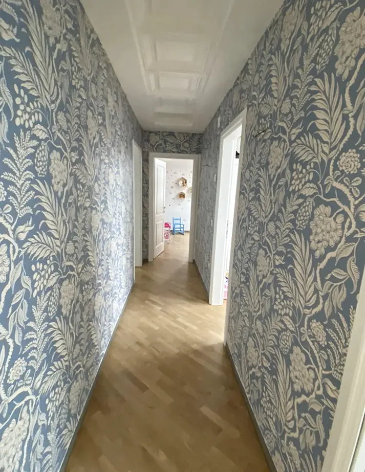 Wallpapering in hallway