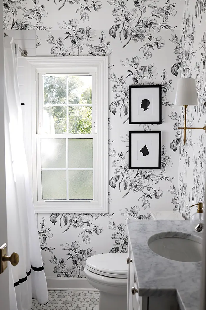 Professional bathroom wallpaper application process showing precision installation